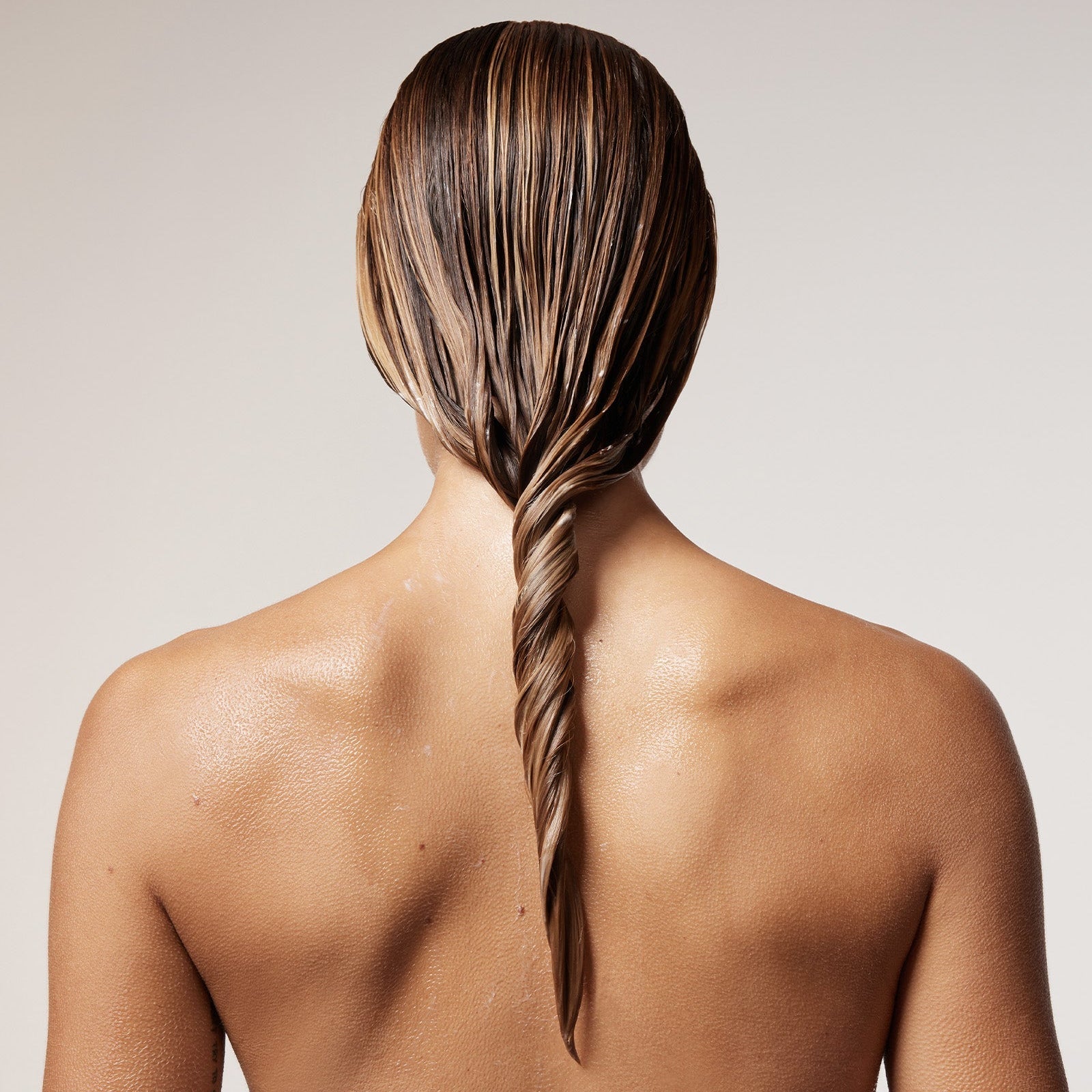 back of woman's brunette and wet hair