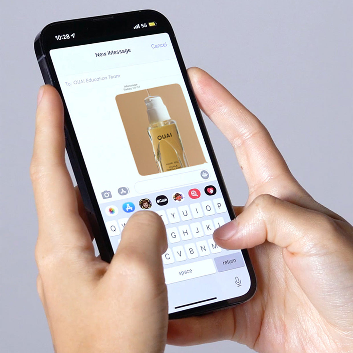 Model hands text a picture of OUAI Hair Oil