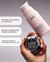 OUAI hair care product with a hand holding a stopwatch on a gray background