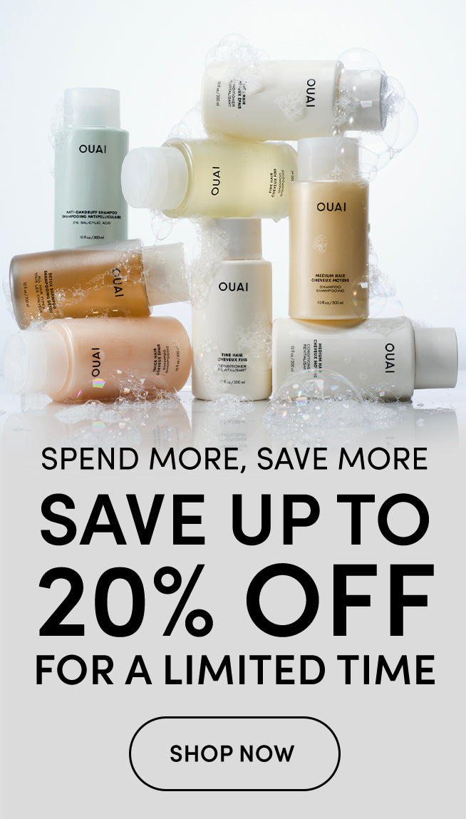 A promotional graphic for OUAI skincare products, showing several bottles and jars arranged on a reflective white surface with water droplets. Large text below reads 'SPEND MORE, SAVE MORE SAVE UP TO 20% OFF FOR A LIMITED TIME' with a 'SHOP NOW' button.