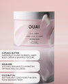 OUAI Melrose Place body creme in a white jar  set against a soft pink background with product details and descriptions on the left.