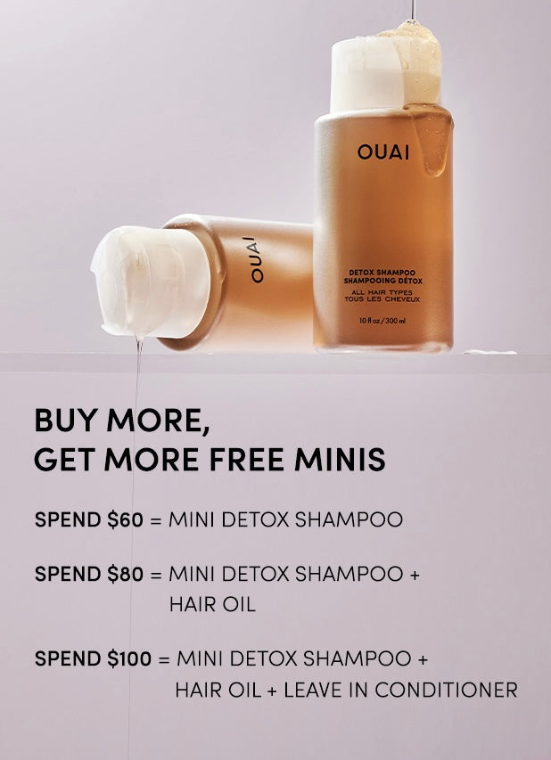 OUAI hair care products with promotional text on a gray background