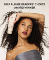 Woman holding aOUAI product with '2025 Allure Readers' Choice Award Winner' text
