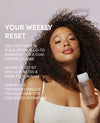 Woman holding a bottle of OUAI hair product with text about its use.