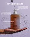 OUAI shampoo bottle with key ingredients text on a gray background