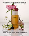 OUAI shampoo bottle with flowers and text about fragrance notes on a light background