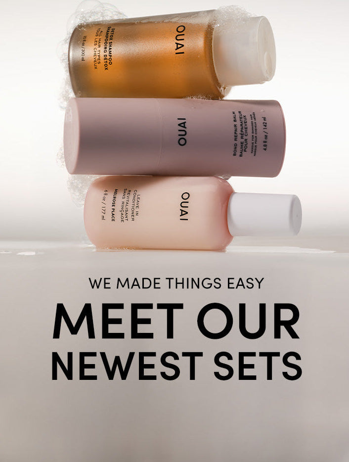 ouai detox shampoo, bond repair balm and leave in conditioner bottles stacked on top of each otheron a white background with text saying "we made things easy. Meet our newest sets" 