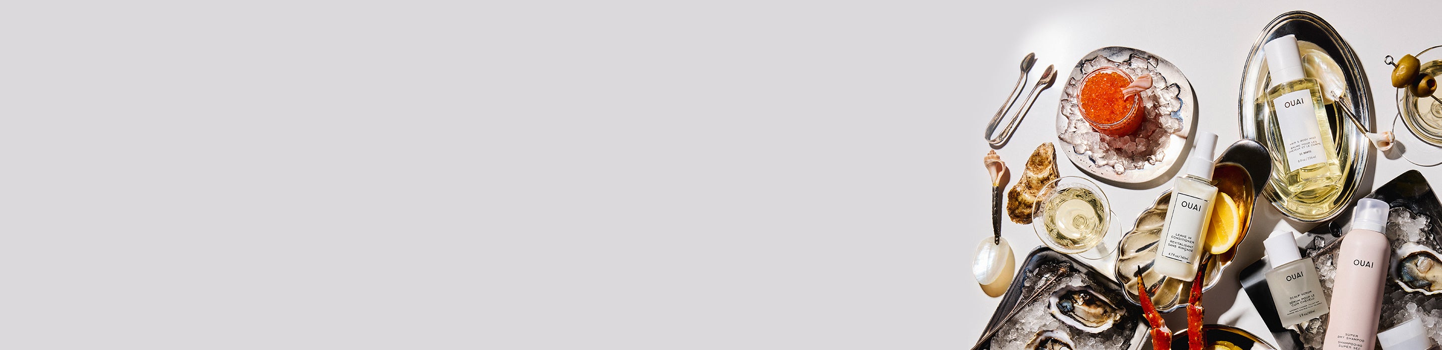 Top-down view of a dining table with food and drinks on a white background