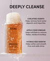 OUAI detox shampoo bottle with text detailing ingredients and benefits on a gray background