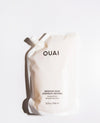 OUAI Medium Hair Shampoo refill pouch in a warm off-white color, featuring black text and a spout cap, photographed on a clean white background with a soft shadow.