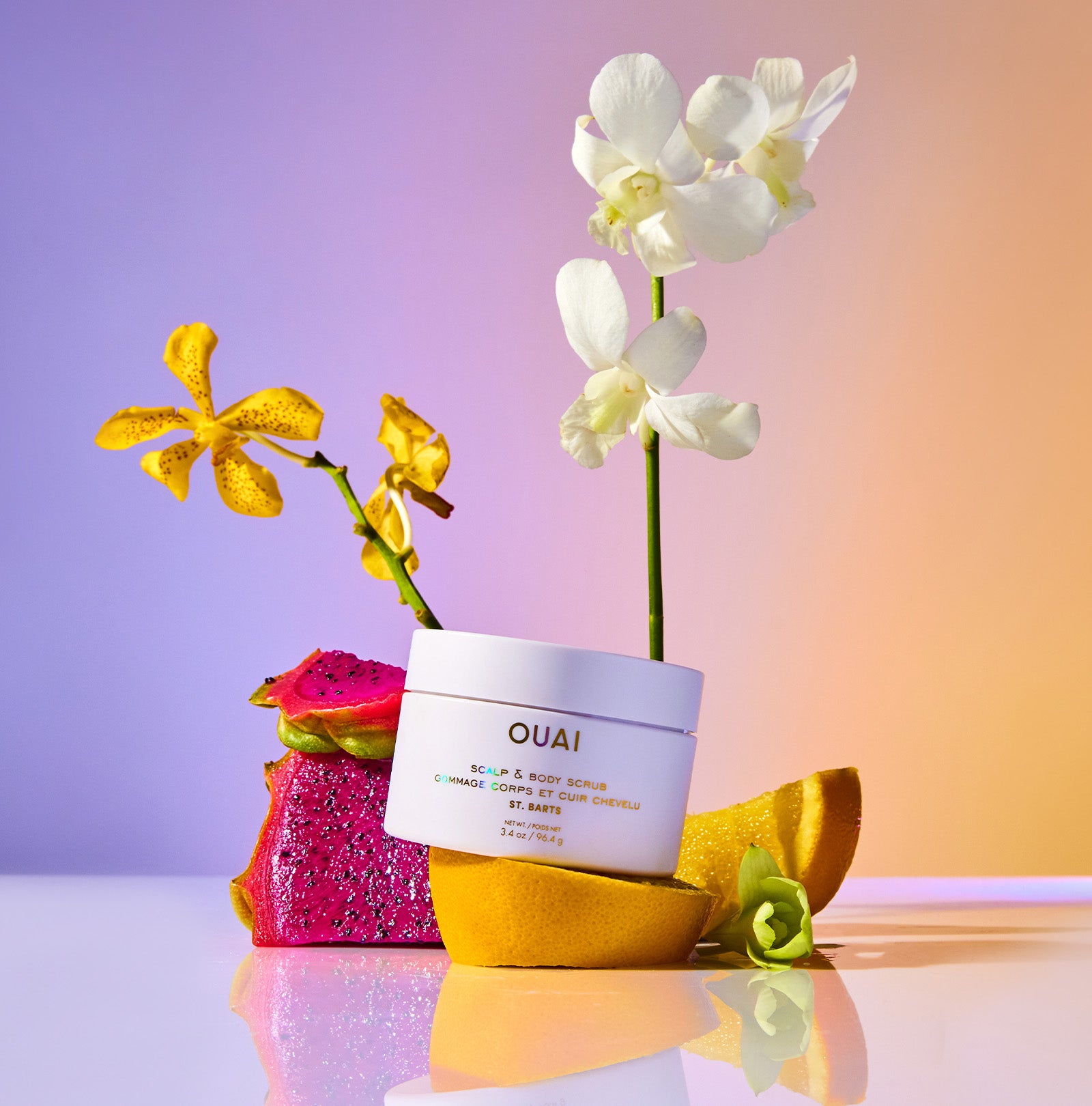 OUAI hair product with flowers on a gradient background