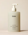 A frosted OUAI Dean Street Hand Wash pump bottle stands upright against a warm neutral background. Text: “OUAI”, “HAND WASH”, “SAVON POUR LES MAINS”, “DEAN STREET”, “16 fl oz / 474 ml”.
