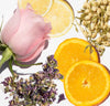 Pink rose, lemon slices, orange slices, and dried flowers on a white background