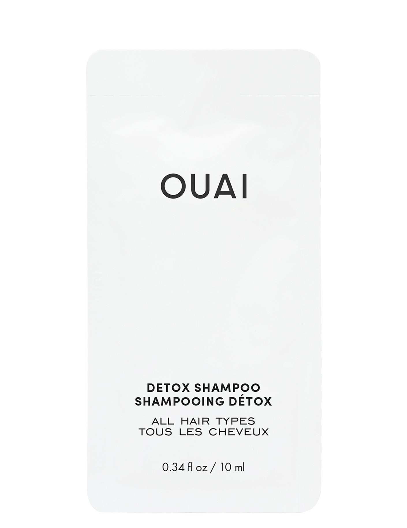 A small, white shampoo packet with the brand name 'OUAI' printed on the front and the text 'DETOX SHAMPOO' above and 'ALL HAIR TYPES' below. .